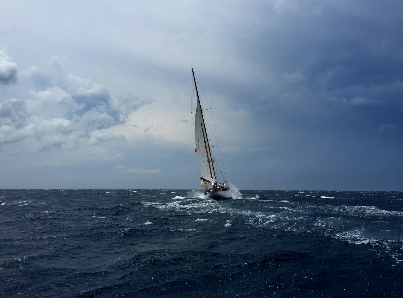 Boat navigating weather and stormy seas Boat navigating weather and stormy seas