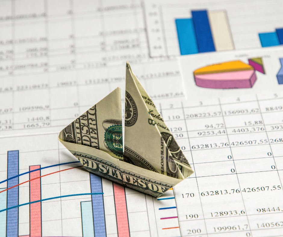 Sailboat made into a dollar while discussing catamaran and monohull price comparison